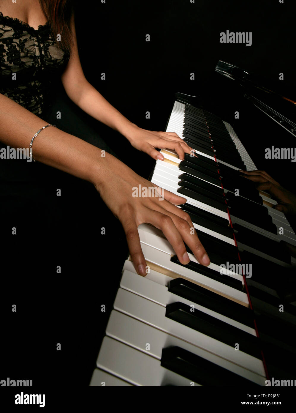 Generic, female pianist playing the grand piano, Stock Photo