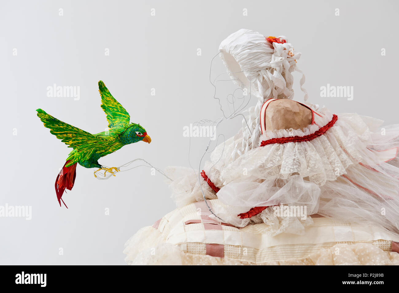 Paper parrot with mannequin wearing paper 18th century style dress Stock Photo