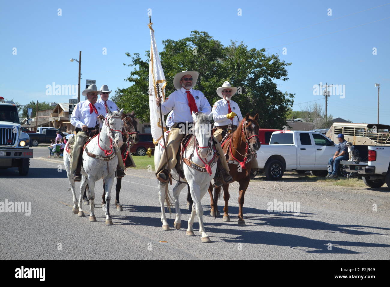 Members of the El Paso County Sheriff’s Posse ride on horseback in the