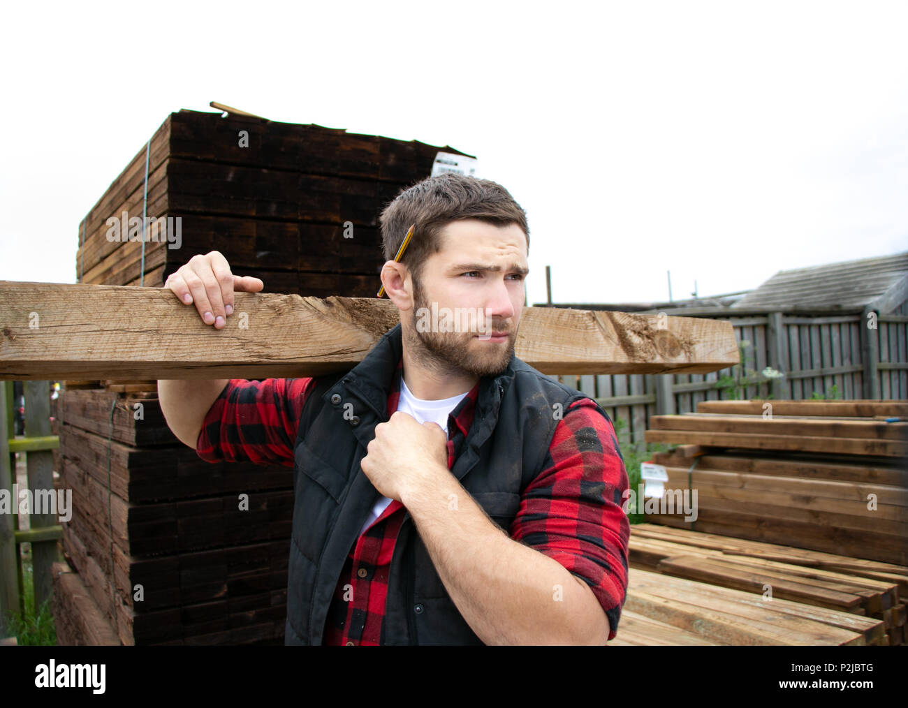 Carpenter, Yard worker, labourer, laborer with tool belt carries long