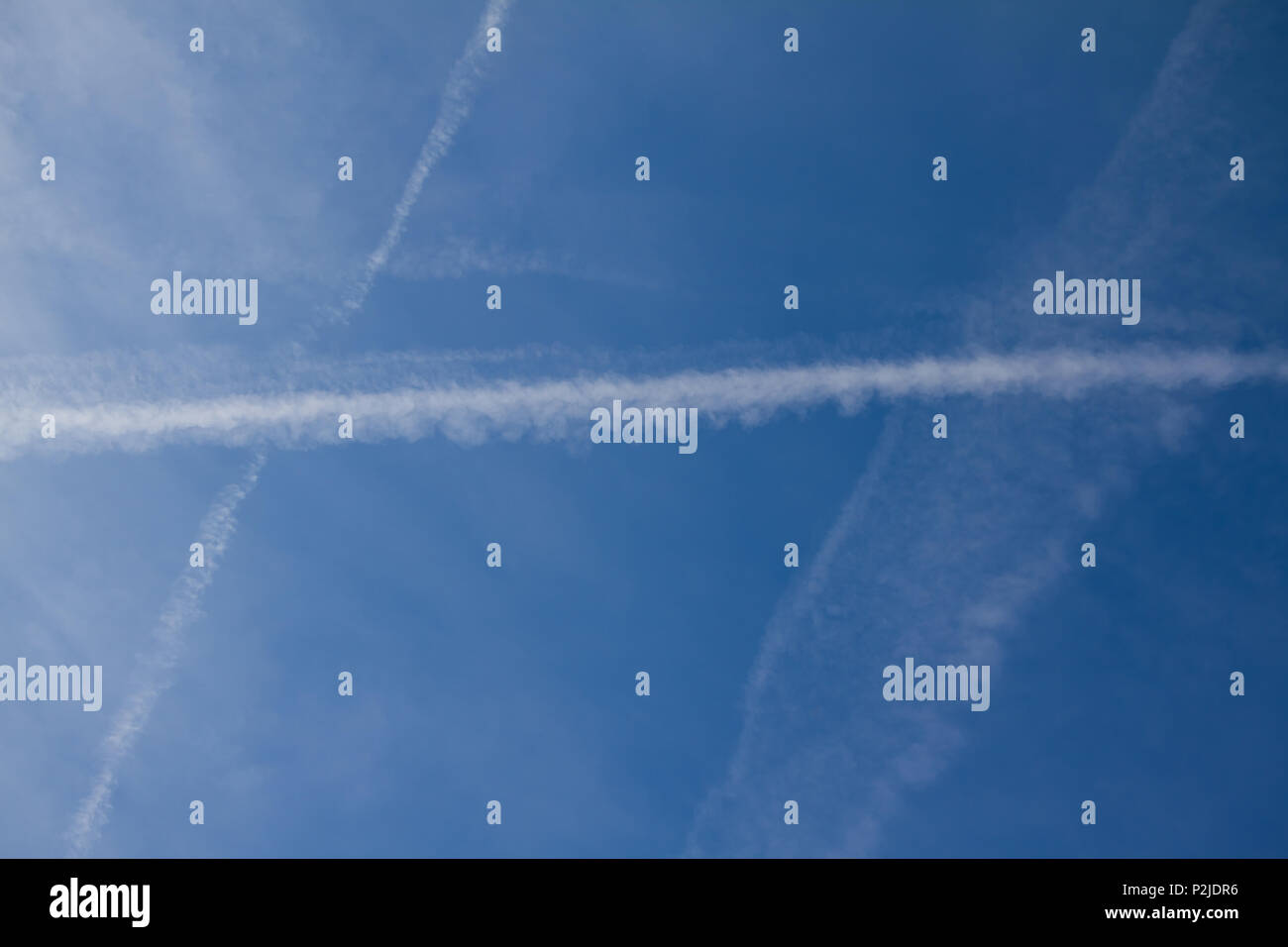 Environmental pollution by planes - chemtrails or contrails Stock Photo
