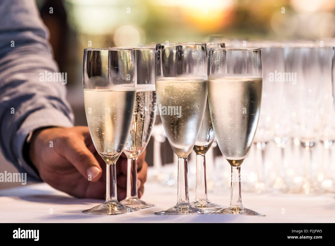 A hand taking a glass of Prosecco. Stock Photo
