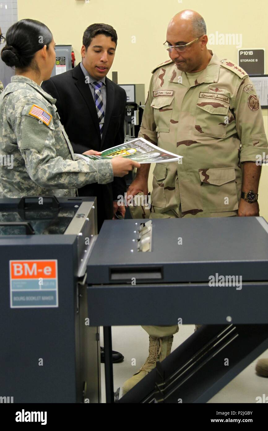 A 4th Military Information Support Group Soldier briefs Brig. Gen. Khalil Essam Mohamed Elsayed (right), commander, Egyptian Human Development and Behavioral Sciences Center, on the equipment and capabilities of the Group’s heavy print detachment during a visit to Fort Bragg, Sept. 24-28. Elsayed and three other Egyptian army officers traveled here to exchange information in order to coordinate training programs and synchronize efforts with U.S. partners. Stock Photo
