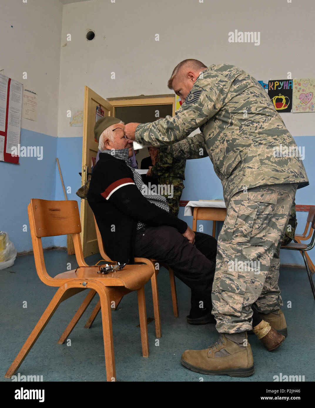 U.S. Air Force Tech. Sgt. William McConaha, ophthalmology technician, 121st Air Refueling Wing Medical Group, gives a new pair of glasses to a patient during a Combined Medical Engagement in Vlase, Serbia, Sept. 8, 2016. The purpose of the engagement was to provide humanitarian assistance by the combined medical teams to the Serbian civilians in the regions, build a working relationship between the Serbian Armed Forces’ and Ohio National Guard's medical teams and lay the groundwork for a future relationship with the Angolan Armed Forces. (U.S. Air National Guard photo by Senior Airman Wendy Ku Stock Photo
