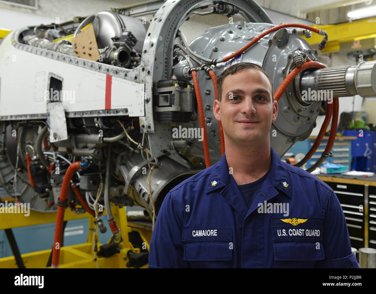 U.s. Coast Guard Petty Officer 3Rd Class Kyle Camaiore, An Aviation  Maintenance Technician Stationed At Air Station Barbers Point, Hawaii,  Poses In Front Of The Engine Of An Hc-130 Hercules Airplane Sept.