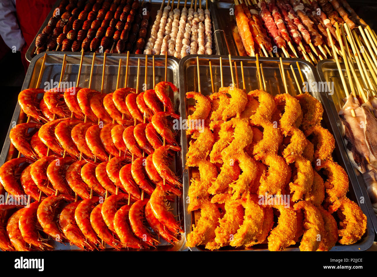 Exotic snacks and desserts can be found in this famous market Donghuamen Night food market near Wangfujing street, Beijing, China Stock Photo