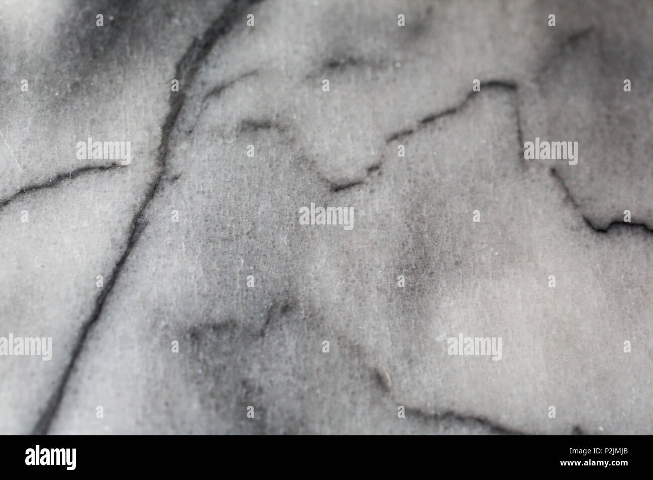 cloudy white and grey marble with black veins macro detail shot Stock Photo