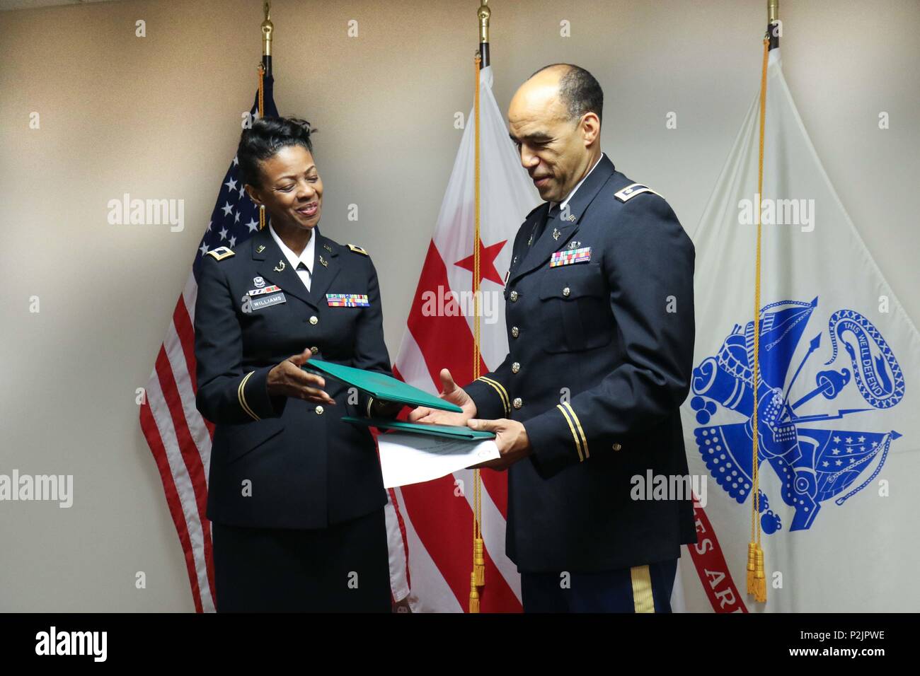 WASHINGTON-Lt. Col. Thaddeus A. Hoffmeister, defense attorney, 352nd Judge  Advocate General Team Support, District of Columbia National Guard receives  an Army Achievement Medal and the Army Commendation Medal from his former  commander, (