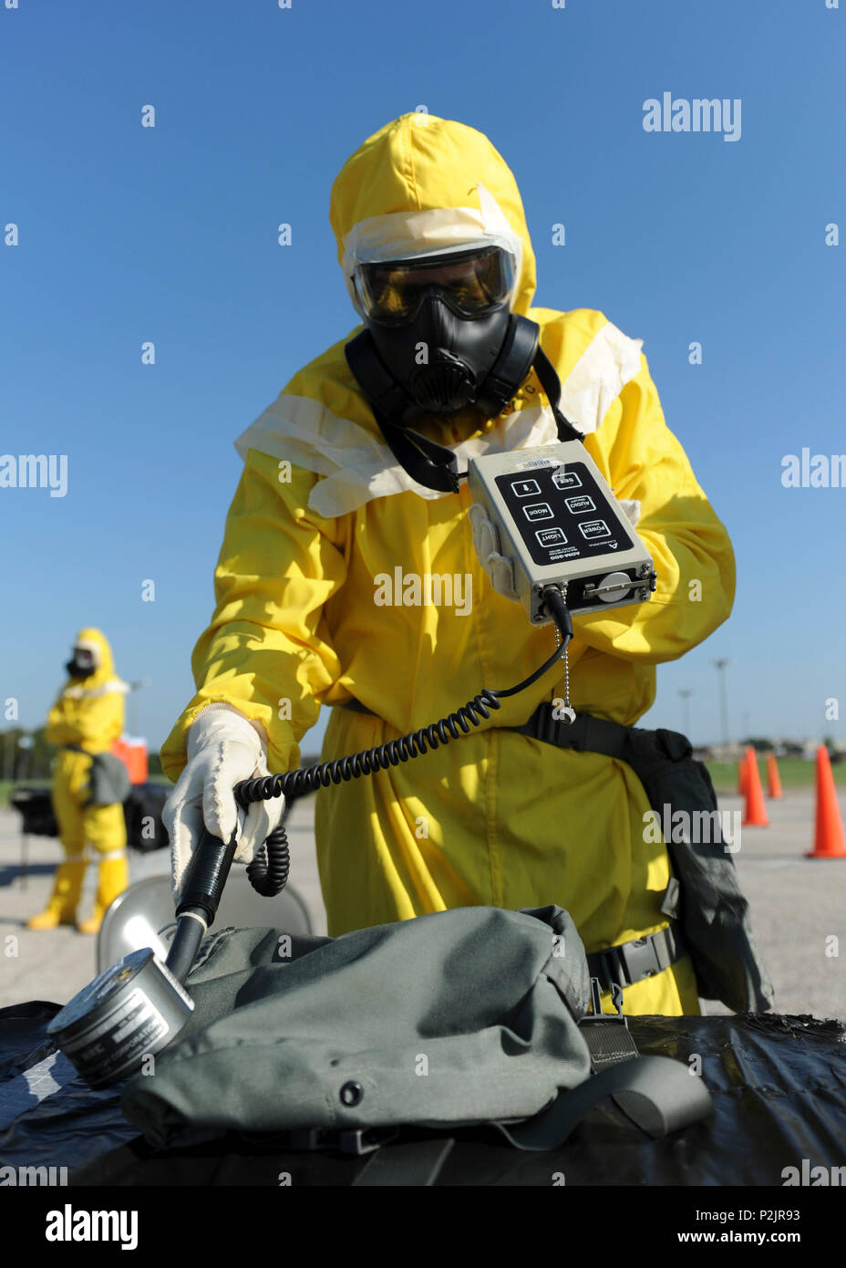 An Emergency Management Support Team (EMST) member simulates checking alpha radiation levels during training at Whiteman Air Force Base, Mo., Sept. 21, 2016. The EMST use ADM-300 multi-functional survey instruments to detect, measure and digitally display alpha, beta, gamma, and x-rays. (U.S. Air Force photo by Senior Airman Danielle Quilla) Stock Photo