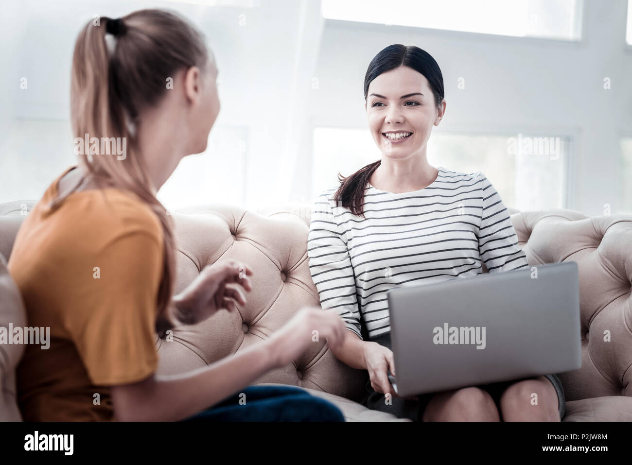 Positive psychologist talking with her client Stock Photo