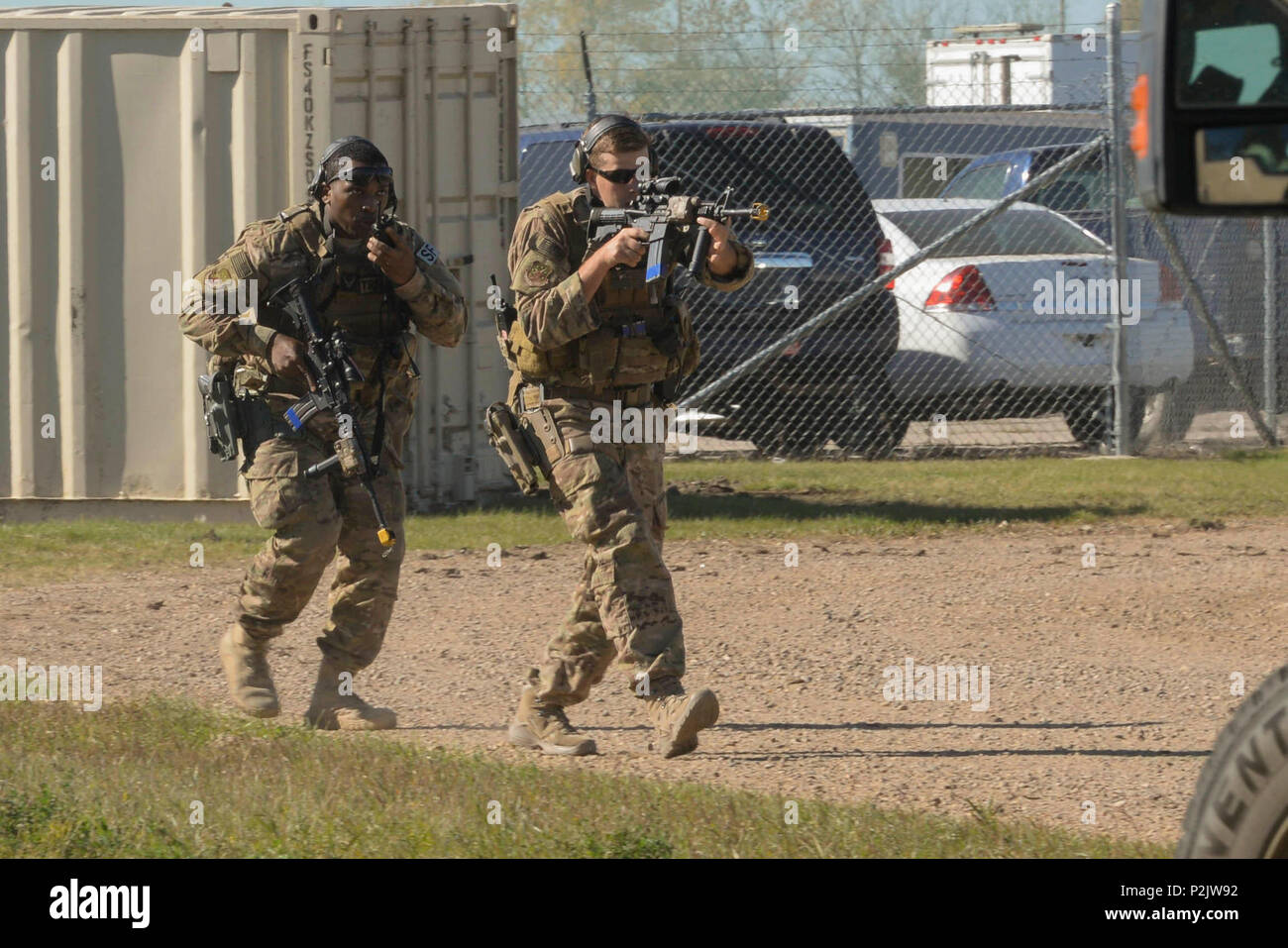 Senior Airmen Zachary Crutchfield and Anthony Fields, 791st Missile Security Forces Squadron tactical response force members, maneuver toward a resource during training at Minot Air Force Base, N.D, Sept. 28, 2016. The recapture and recovery training was designed to prepare missile response force and TRF members on how to conduct convoy response during a launch facility recapture. (U.S. Air Force photo/Airman 1st Class Jessica Weissman) Stock Photo