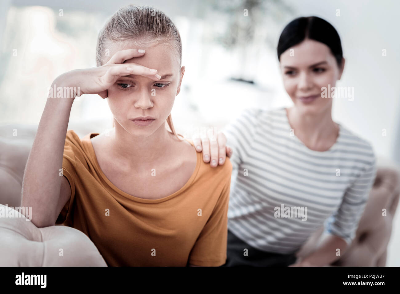 Portrait of upset girl and her mother Stock Photo