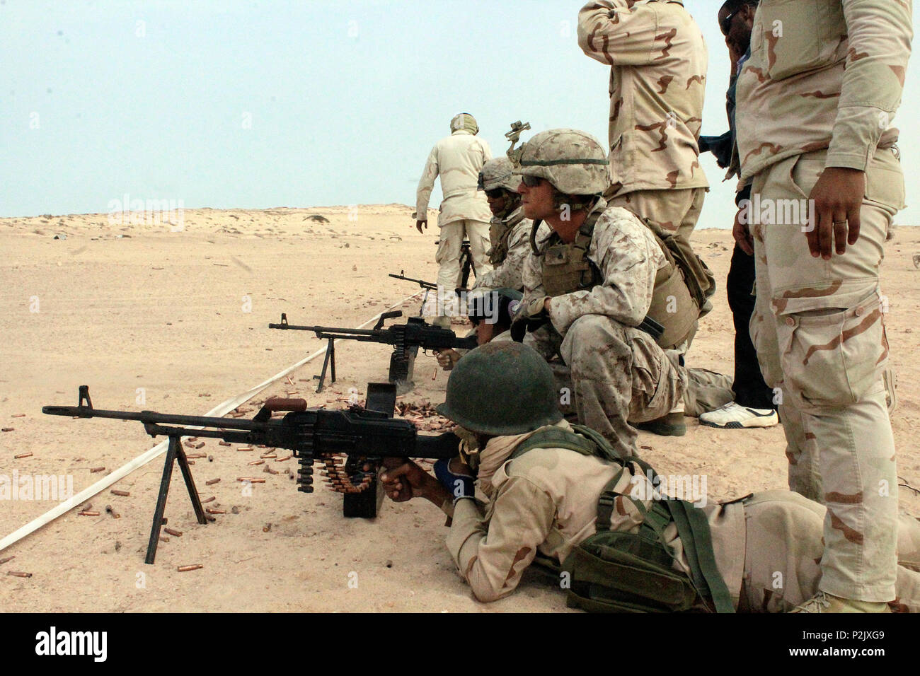 U.S. Marine Corps Cpl. Austin D’Antonio, a team leader with Special Purpose Marine Air-Ground Task Force Crisis Response-Africa, observes a Mauritanian Fusilier Marin fire his weapon during a machine gun range near Rosso, Mauritania, Sept 21,, 2016. Marines worked on small unit tactics, detainee procedures, weapons handling and marksmanship techniques while training with the Mauritanian FUMA to aid in the suppression of illicit trafficking in the region. U.S. Marines and Sailors assigned to Special Purpose Marine Air-Ground Task Force-Crisis Response-Africa Command support operations, continge Stock Photo