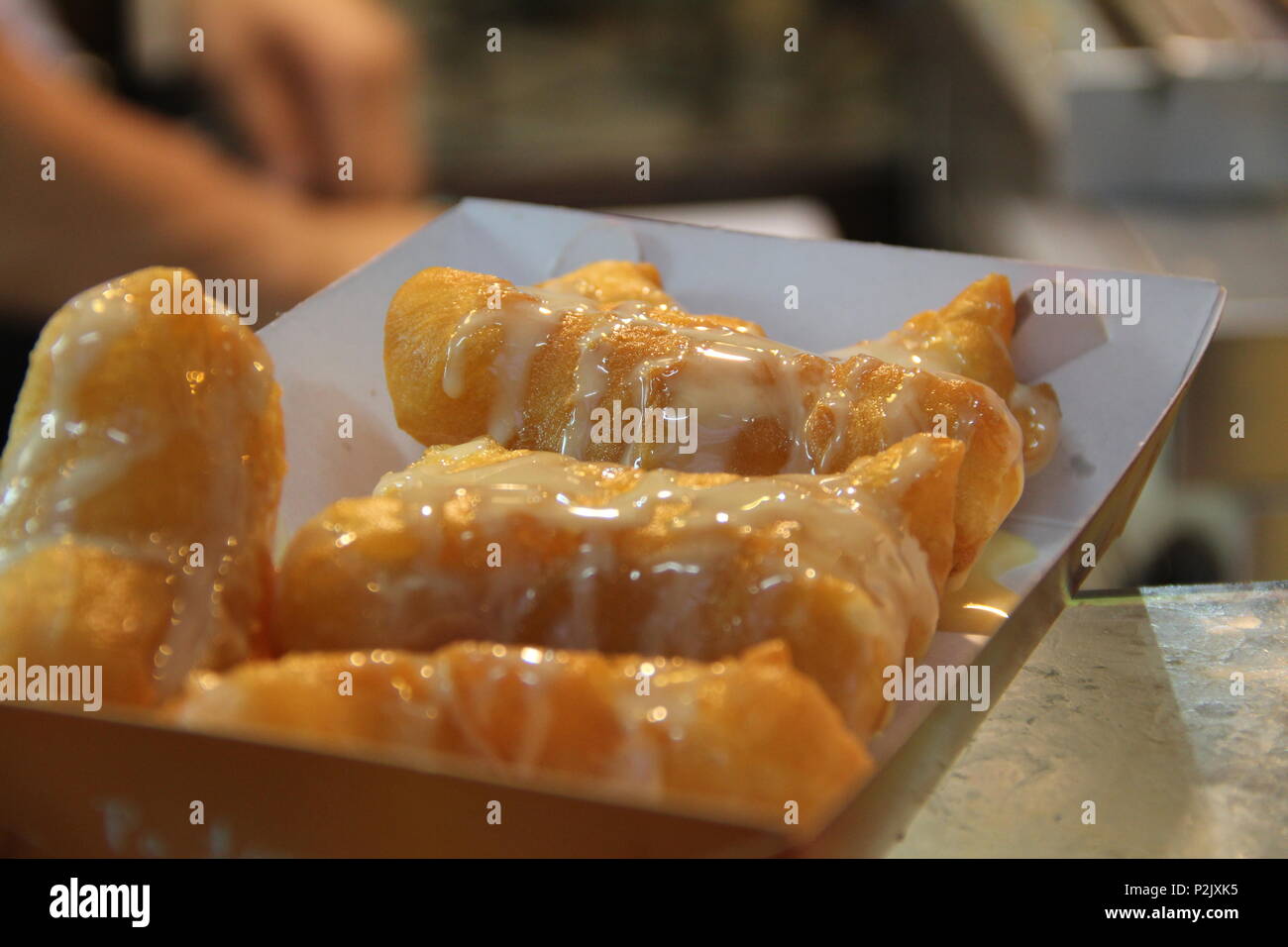 deep fried dough stick with sweetened condensed milk topping Stock