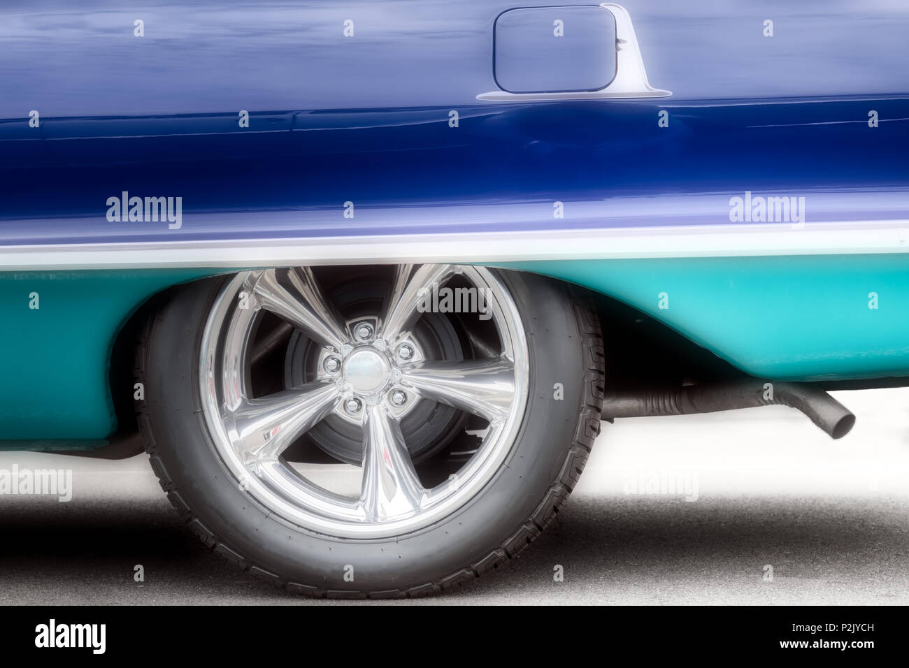 A classic American car, with updated hubcaps, from the sixties in two tone blue. Stock Photo