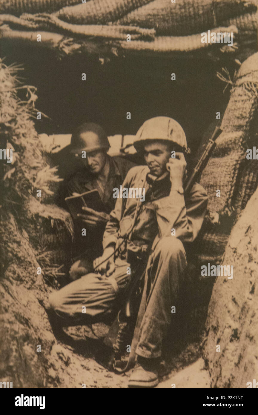 U.S. Army 2nd Lt. William H. Funchess (on radio) and Sgt. O.J. Mixon, both in the 19th Infantry Regiment, maintain cover in a bunker on the bank of the Kum River north of Taejon, South Korea, July, 1950. 'That was my first engagement. There were 13 Russian T-34 tanks across the river firing point-blank into us.' Funchess was captured on Nov. 4, 1950 after a fierce fight with an overwhelming Chinese force. He endured 34 months as a prisoner of war before finally being released on Sept. 6, 1953. (Photo courtesy of William Funchess) Stock Photo
