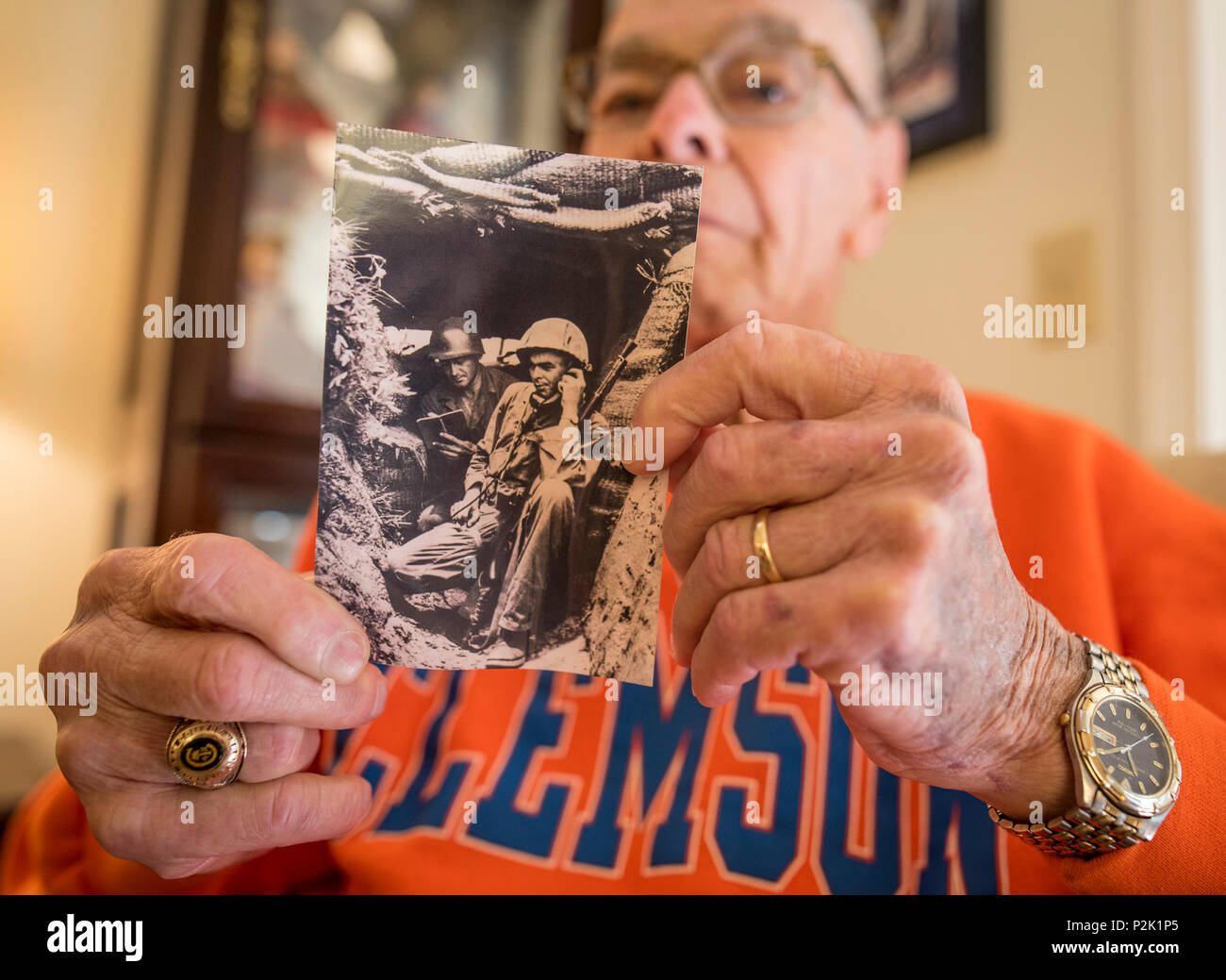 Former U.S. Army 1st Lt. William H. Funchess, 89, who endured 34 months as a prisoner of war during the Korean War, holds a photo of himself in a bunker taken during an engagement in July of 1950 near the Kum River north of Taejon, South Korea, Sept. 21, 2016. 'That was my first engagement. There were 13 Russian T-34 tanks across the river firing point-blank into us.' After his capture on Nov. 4 of that same year, Funchess was held in the same prison compound and became very close to Army Chaplain Father Emil J. Kapaun, who received the Medal of Honor posthumously in 2013 for his acts of coura Stock Photo