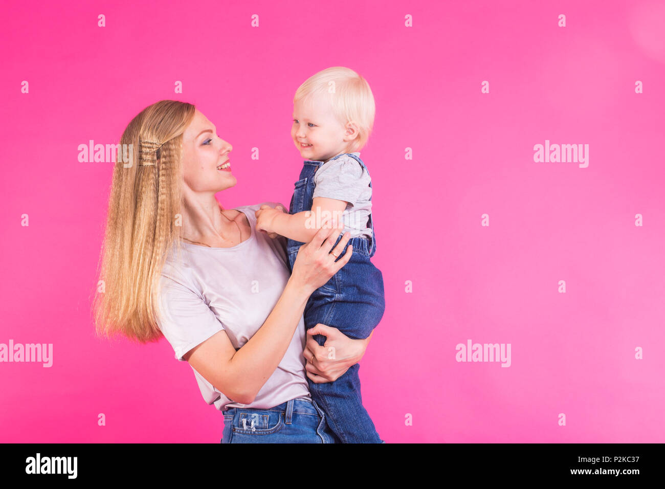 Funny family on pink background. Mother and her daughter girl. Mom and ...