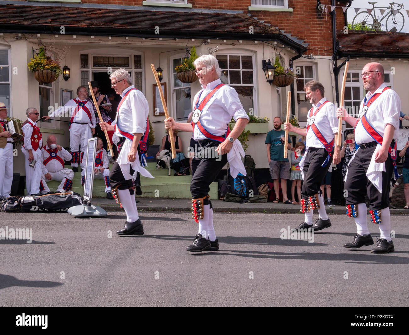 Morris dancers dance outside the Vine public house in Great Bardfield