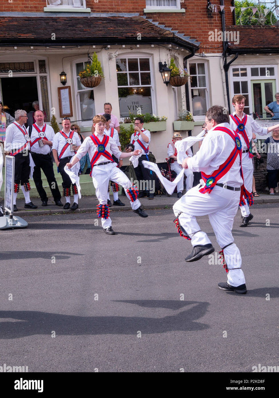Morris dancers dance outside the Vine public house in Great Bardfield