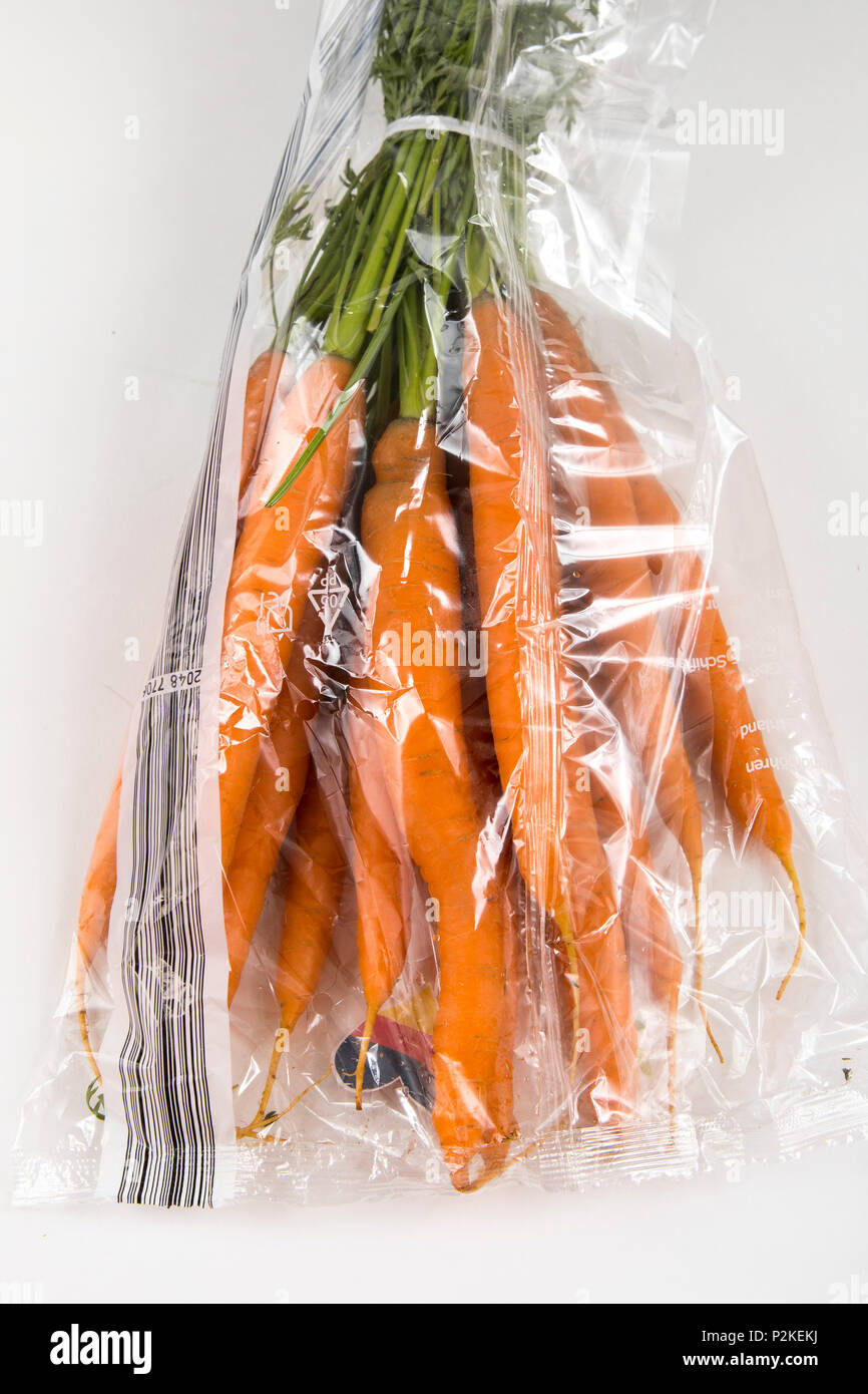 Fresh food, vegetables , each individually packaged in plastic wrap, all food is available in the same supermarket even without plastic packaging, car Stock Photo