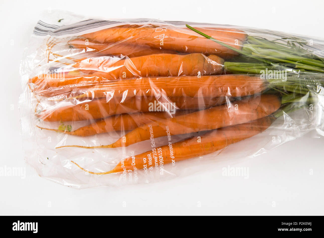 Fresh food, vegetables , each individually packaged in plastic wrap, all food is available in the same supermarket even without plastic packaging, car Stock Photo
