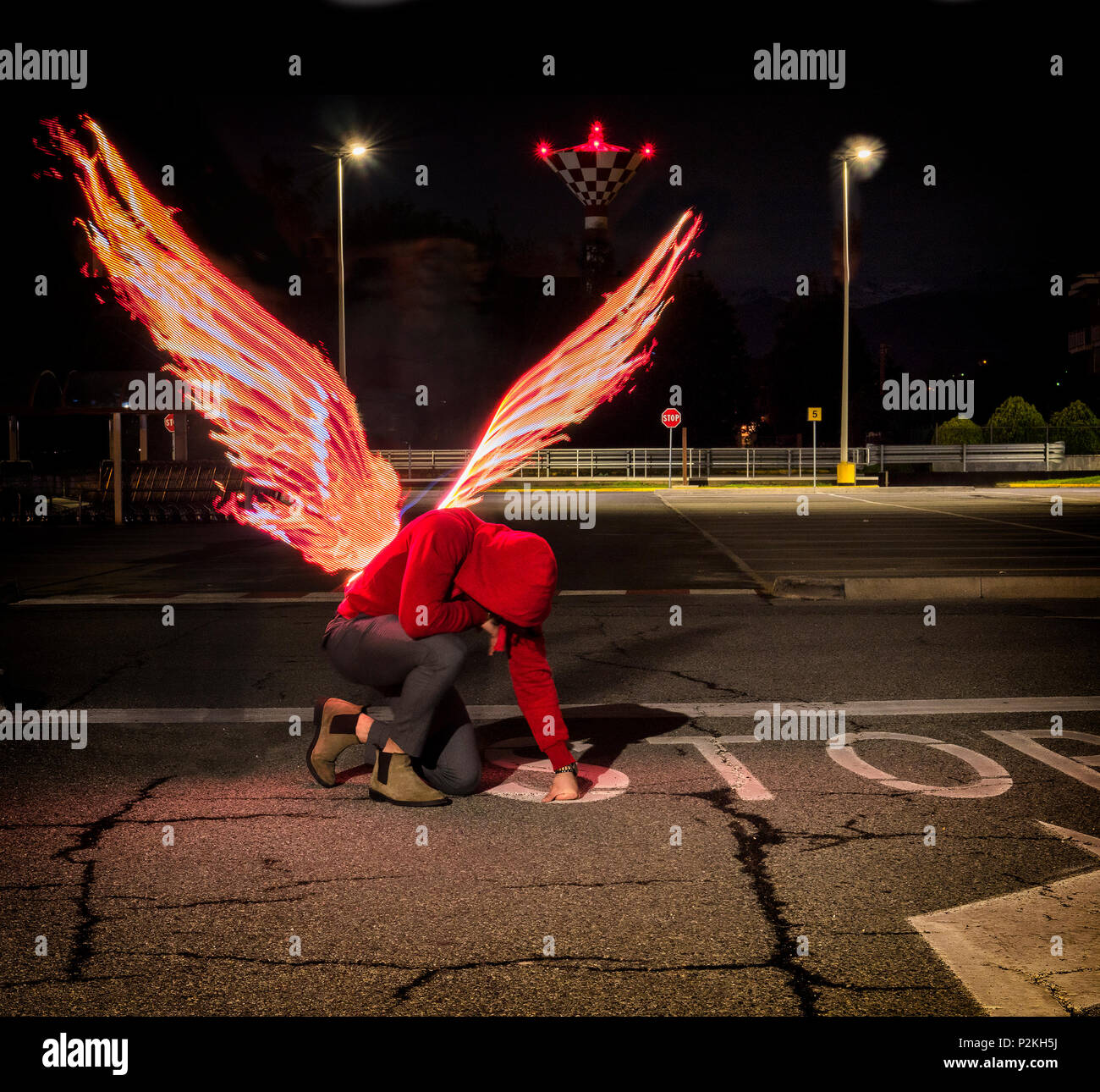 Fallen male angel with fire wings Stock Photo