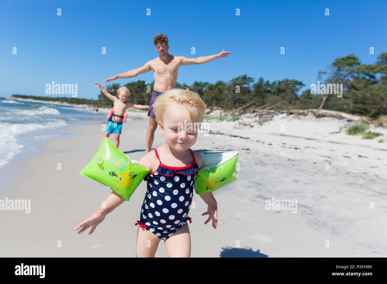 Young family on the beach, young daughter, father and brother on the sandy beach between Strandmarken und Dueodde, baltic sea, M Stock Photo
