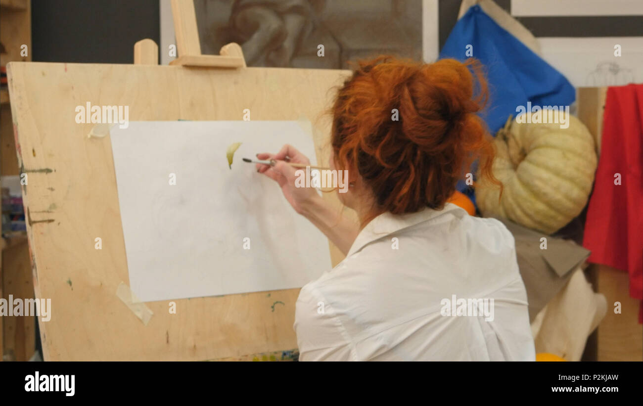 Female artist working on watercolor painting in studio Stock Photo - Alamy