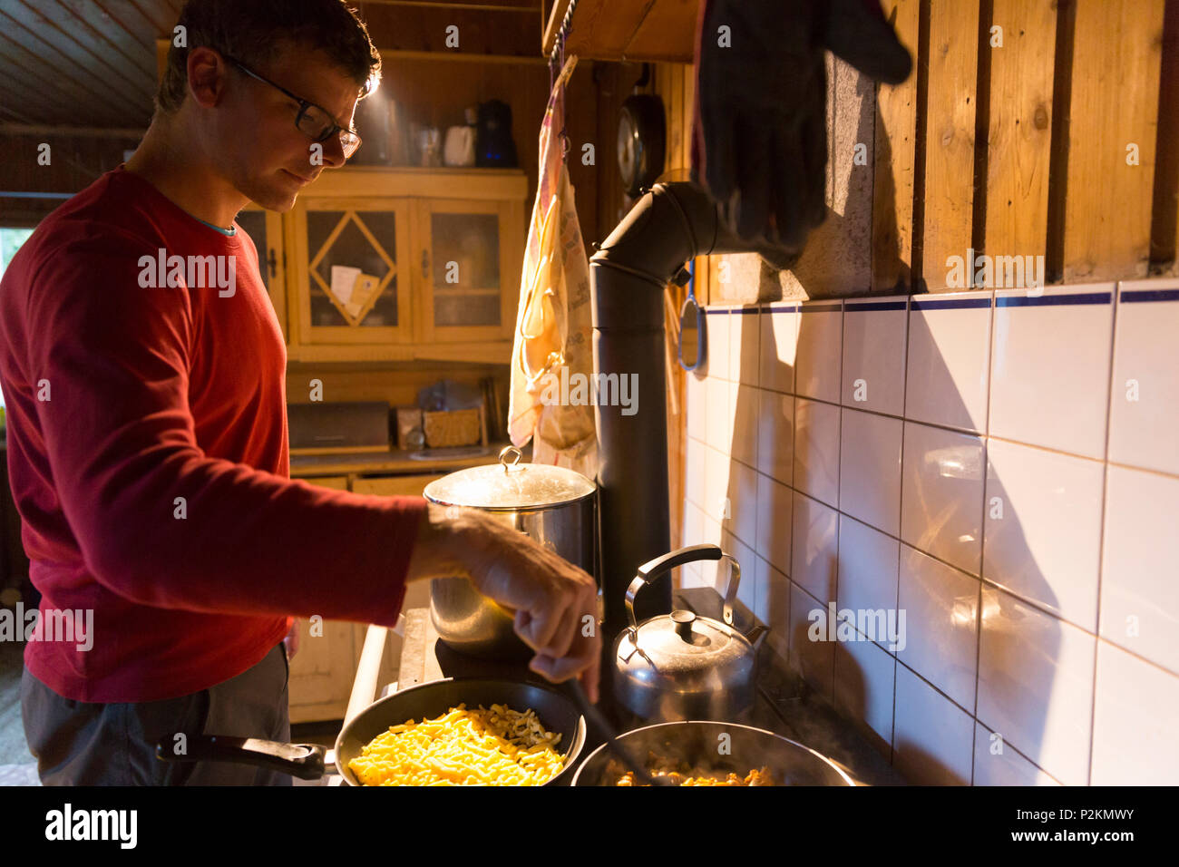 Cooking inside the mountain hut, alp, MR, Maria Alm, Berchtesgadener Land, Alps, Austria, Europe Stock Photo