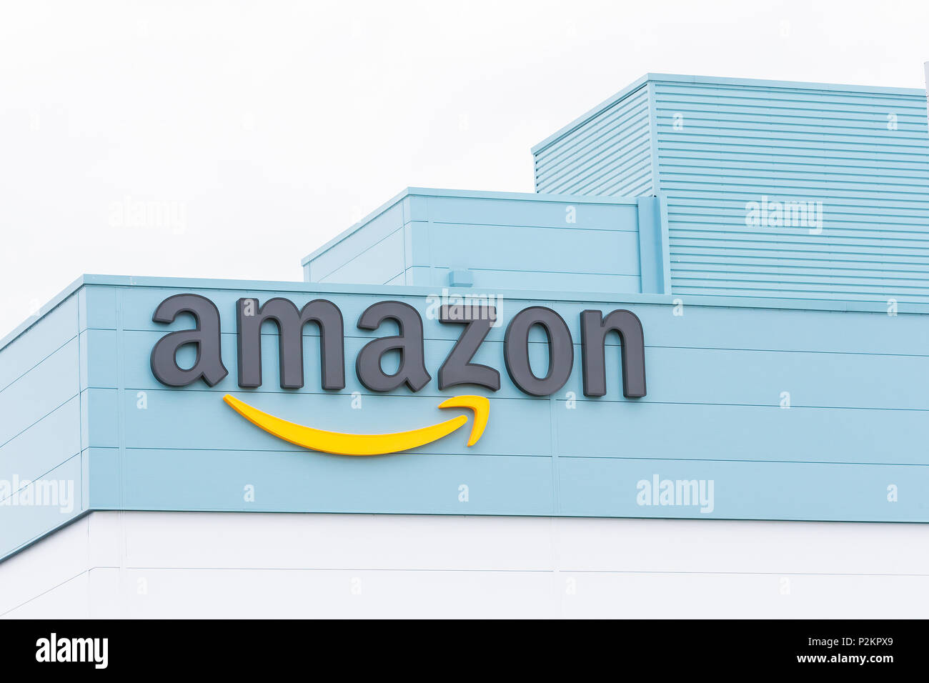 15 June 2018 - Amazon sign and logo on their Warrington Fulfilment Centre building on the day of their official opening Stock Photo
