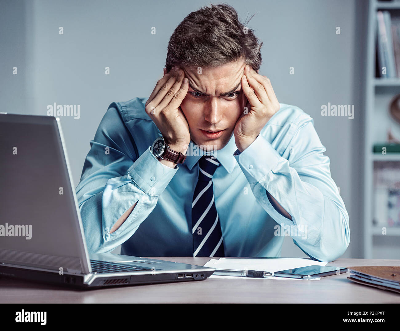 Young worker sitting in his office thinking. Business concept Stock Photo
