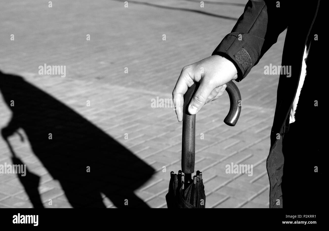 Young man holding umbrella Stock Photo - Alamy