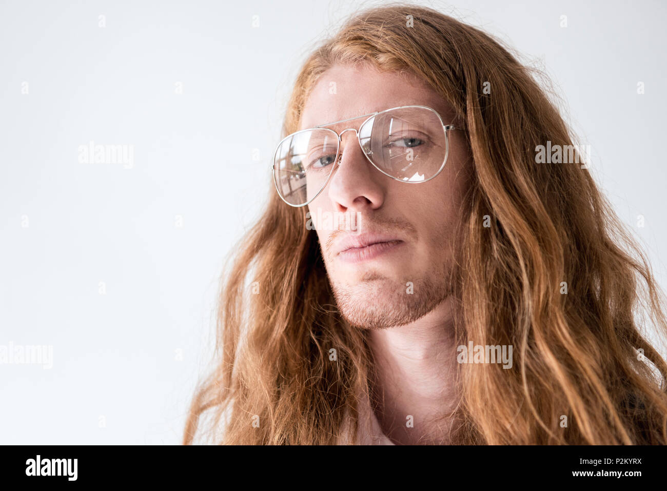 Portrait Of Handsome Man With Curly Ginger Hair And Glasses