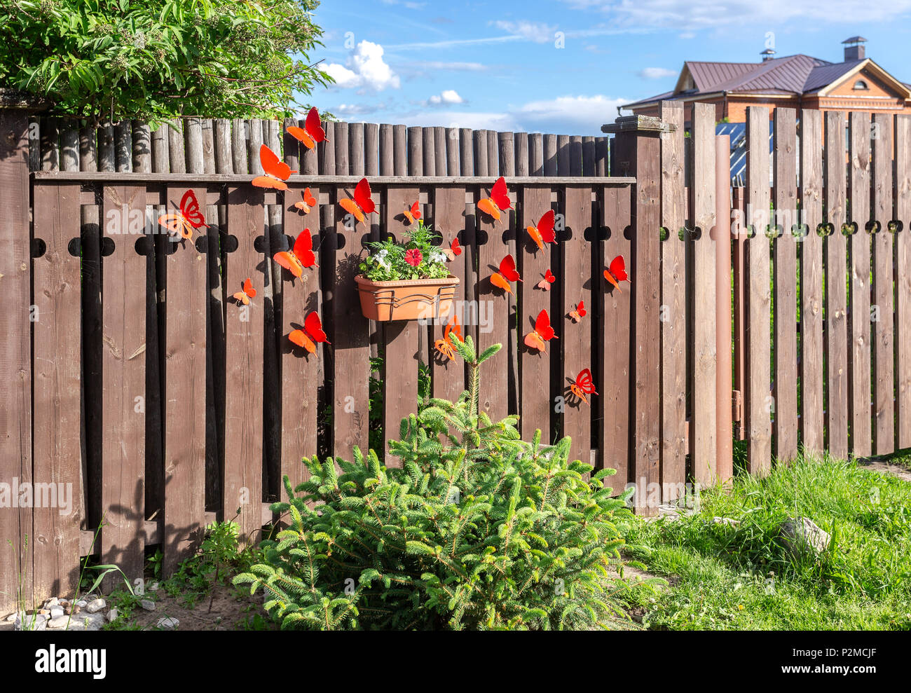 Flower pot with decorative flowers hanging on the wooden fence in village  Stock Photo - Alamy