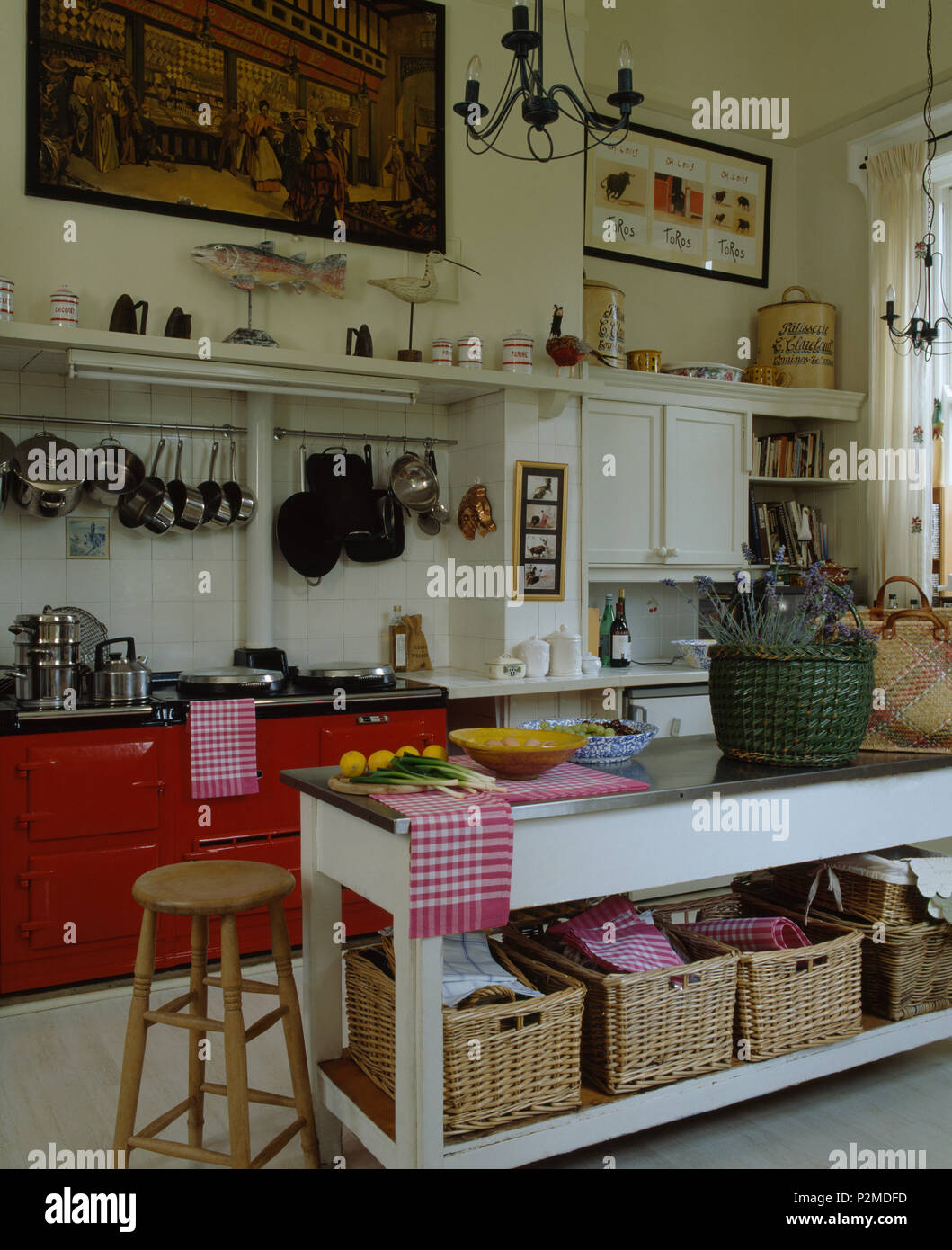 storage shelf baskets on Storage Baskets On Low Shelf On Island Unit With Stainless Steel Worktop In Country Kitchen With Red Double Aga Stock Photo Alamy