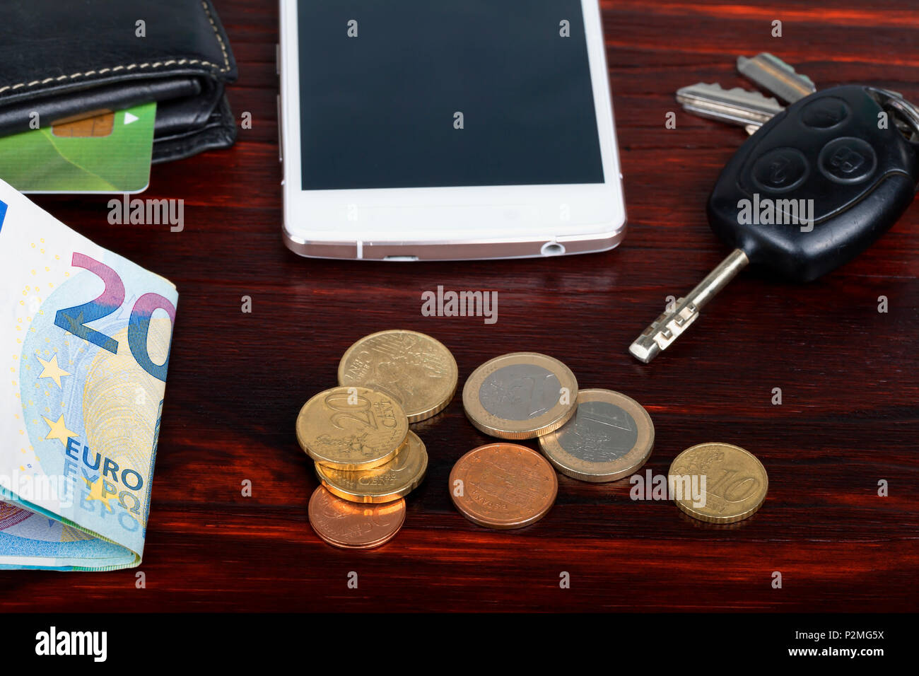 House and car keys, wallet, mobile phone and face mask on wooden surface.  Ready to go out in the new world Stock Photo - Alamy