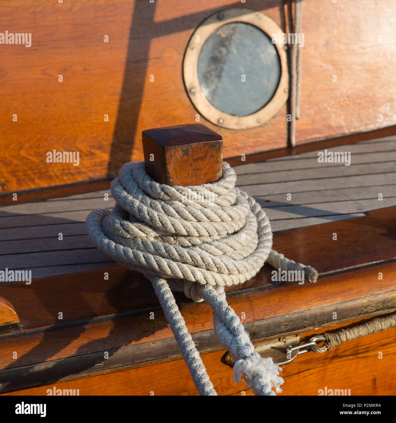 Detail of an old wooden sailing ship with rope and porthole Stock Photo