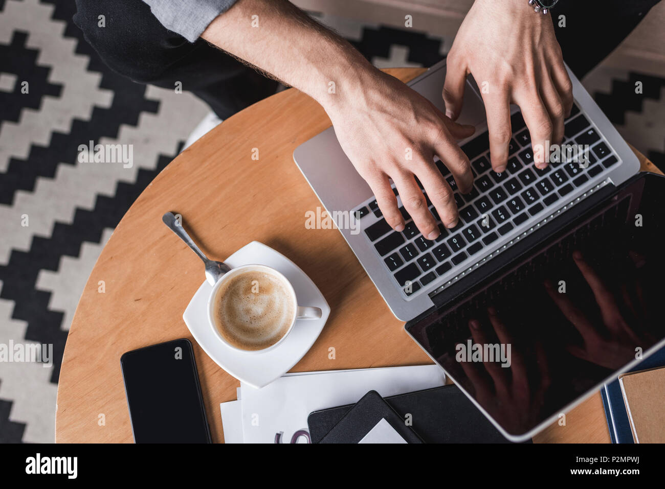 cropped shot fo man using laptop on coffee table Stock Photo