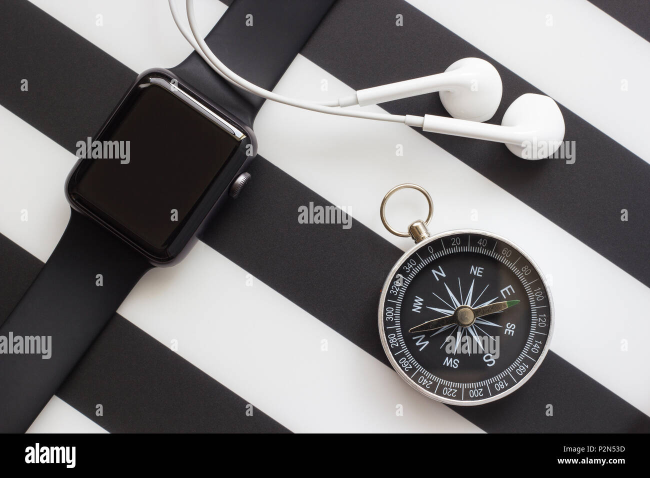 clock, headphones and compass on a black and white background Stock Photo