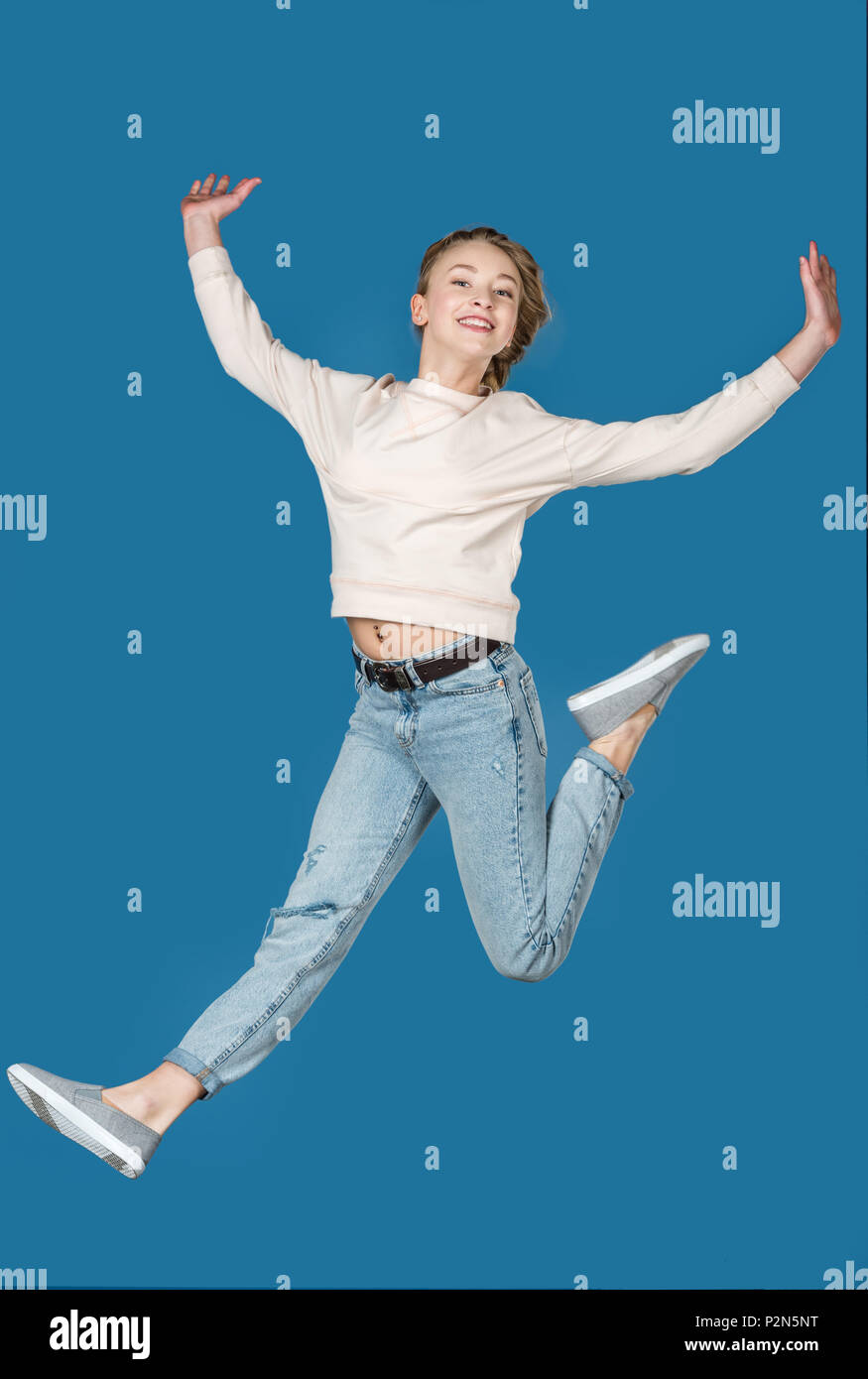 Girl jumping isolated on blue hi-res stock photography and images - Alamy