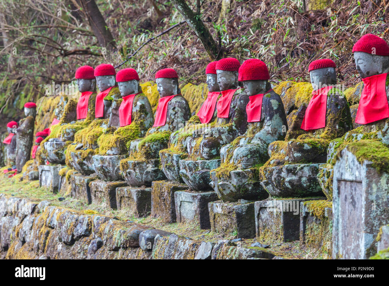 Jizo figures decorated with red knitted caps in Nikko, Tochigi Prefecture, Japan Stock Photo
