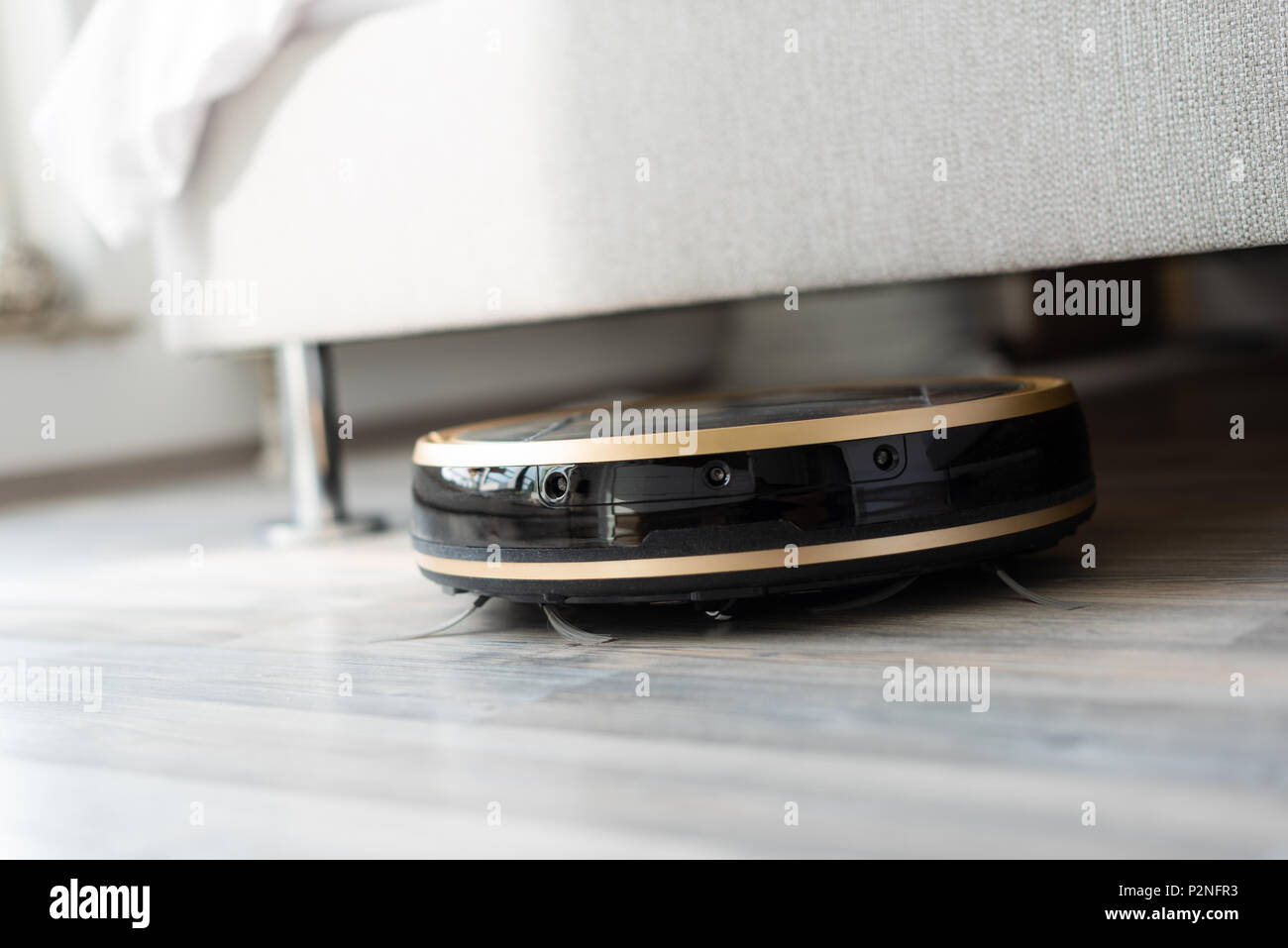 Robot Vacuum Cleaner Runs Under Bed Stock Photo Alamy