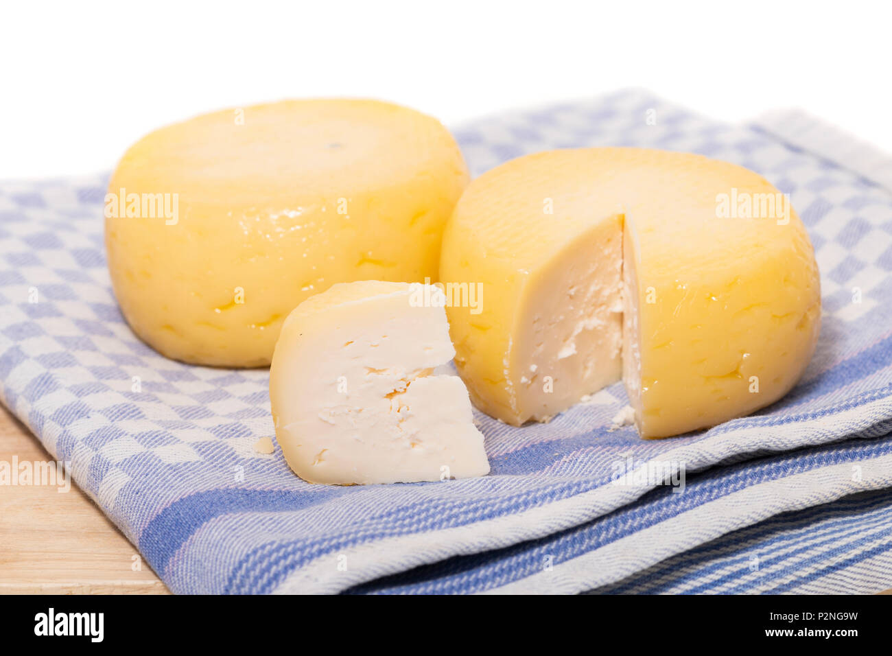Yellow goat cheese isolated on a white background Stock Photo Alamy