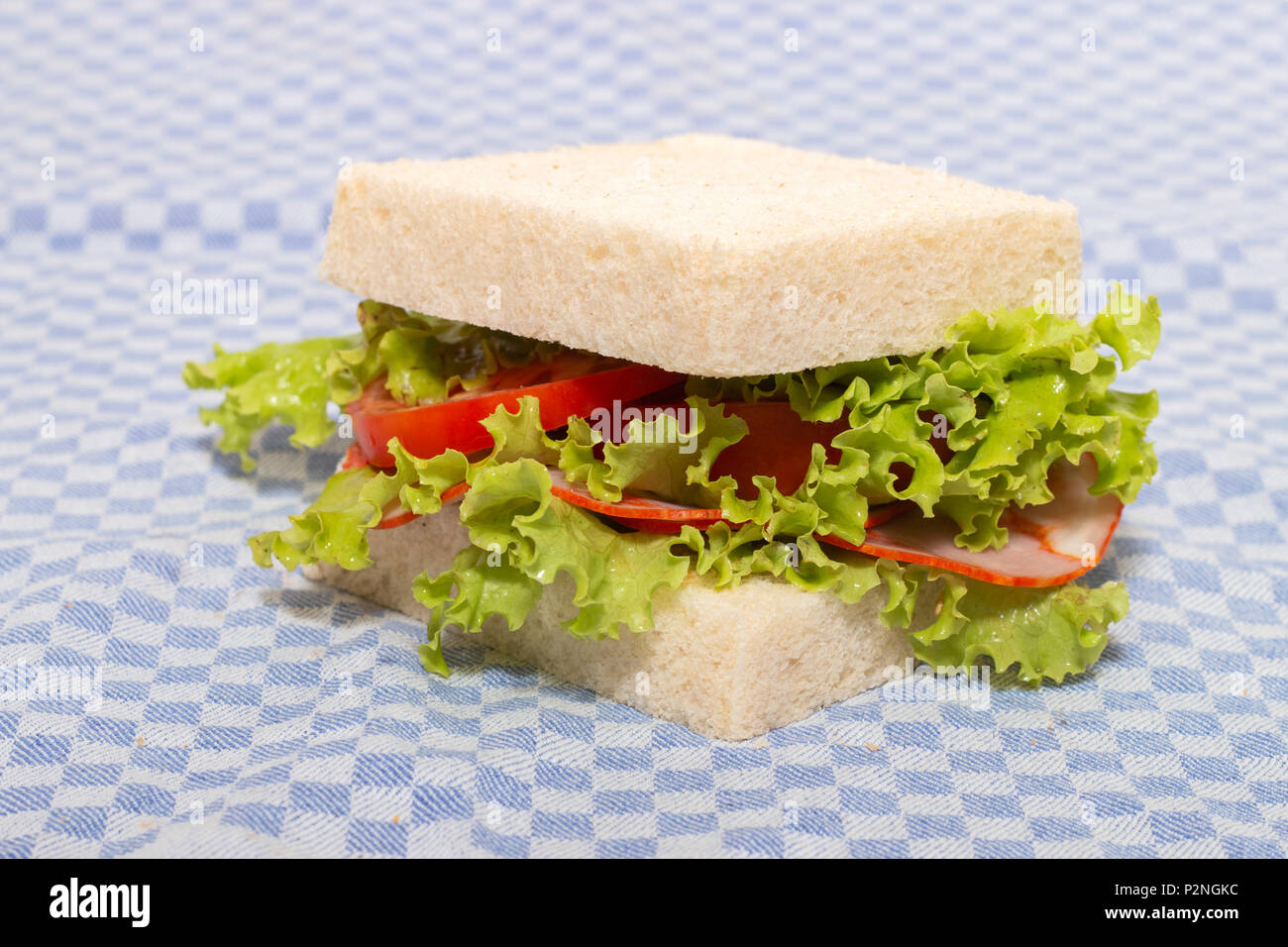 sandwich with paio sausage over a blue cloth. Stock Photo