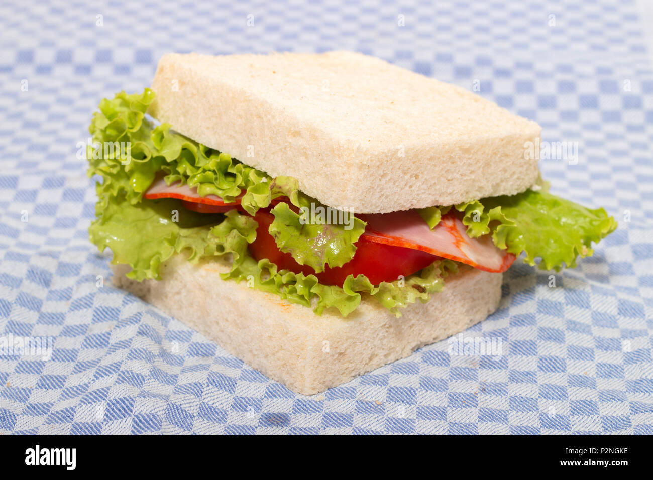 sandwich with paio sausage over a blue cloth. Stock Photo