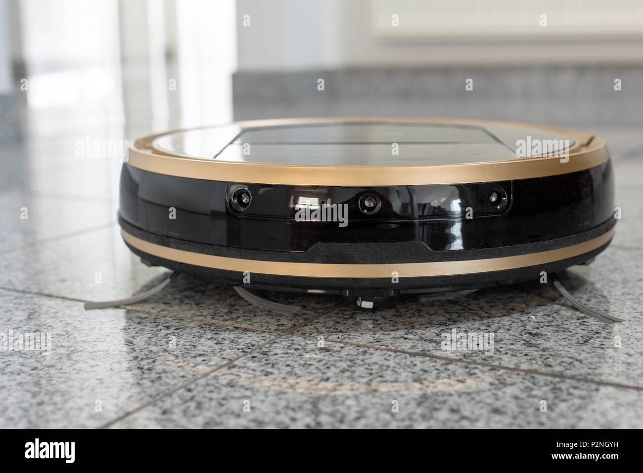 Robotic vacuum cleaner on bright marble floor Stock Photo Alamy