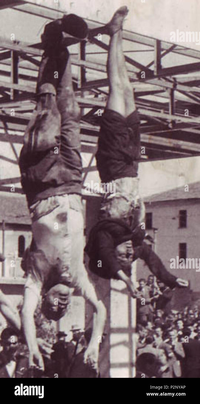 . English: The dead body of Benito Mussolini next to his mistress Claretta Petacci, on display in Milan on 29 April 1945, in Piazzale Loreto, the same place that the fascists had displayed the bodies of fifteen Milanese civilians a year earlier after executing them in retaliation for resistance activity. The photograph is by Vincenzo Carrese. The bodies, from left to right, are: Benito Mussolini Claretta Petacci  Deutsch: Die Leichen von Benito Mussolini und seiner Gefährtin Claretta Petacci in Mailand am 29. April 1945. Photo von Vincenzo Carrese. Von links nach rechts: Benito Mussolini Clare Stock Photo