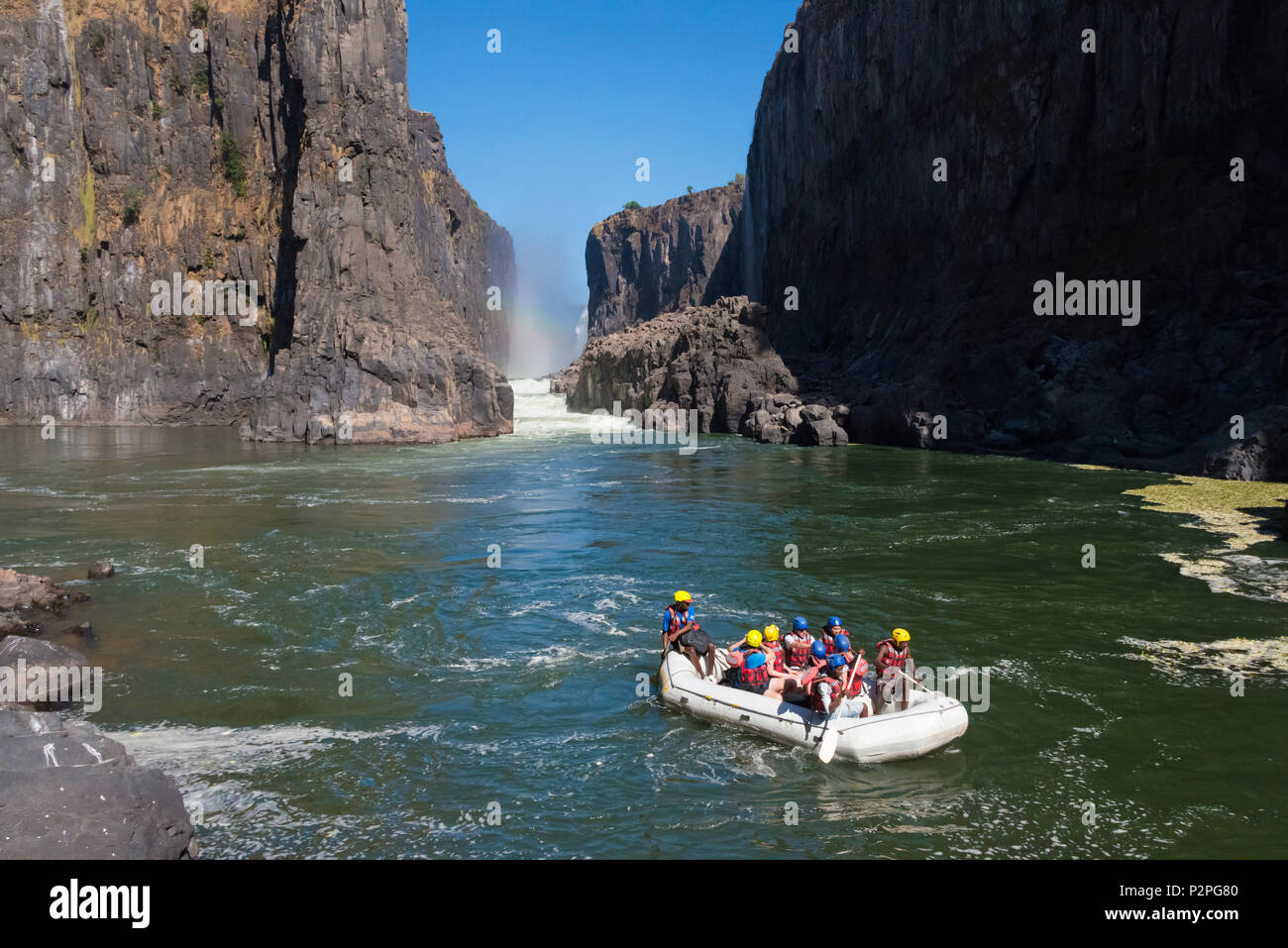 Tourists rafting at the bottom of Victoria Falls, Zimbabwe Stock Photo