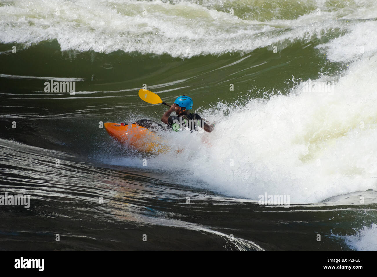 Tourist white water kayaking at the bottom of Victoria Falls, Zimbabwe Stock Photo